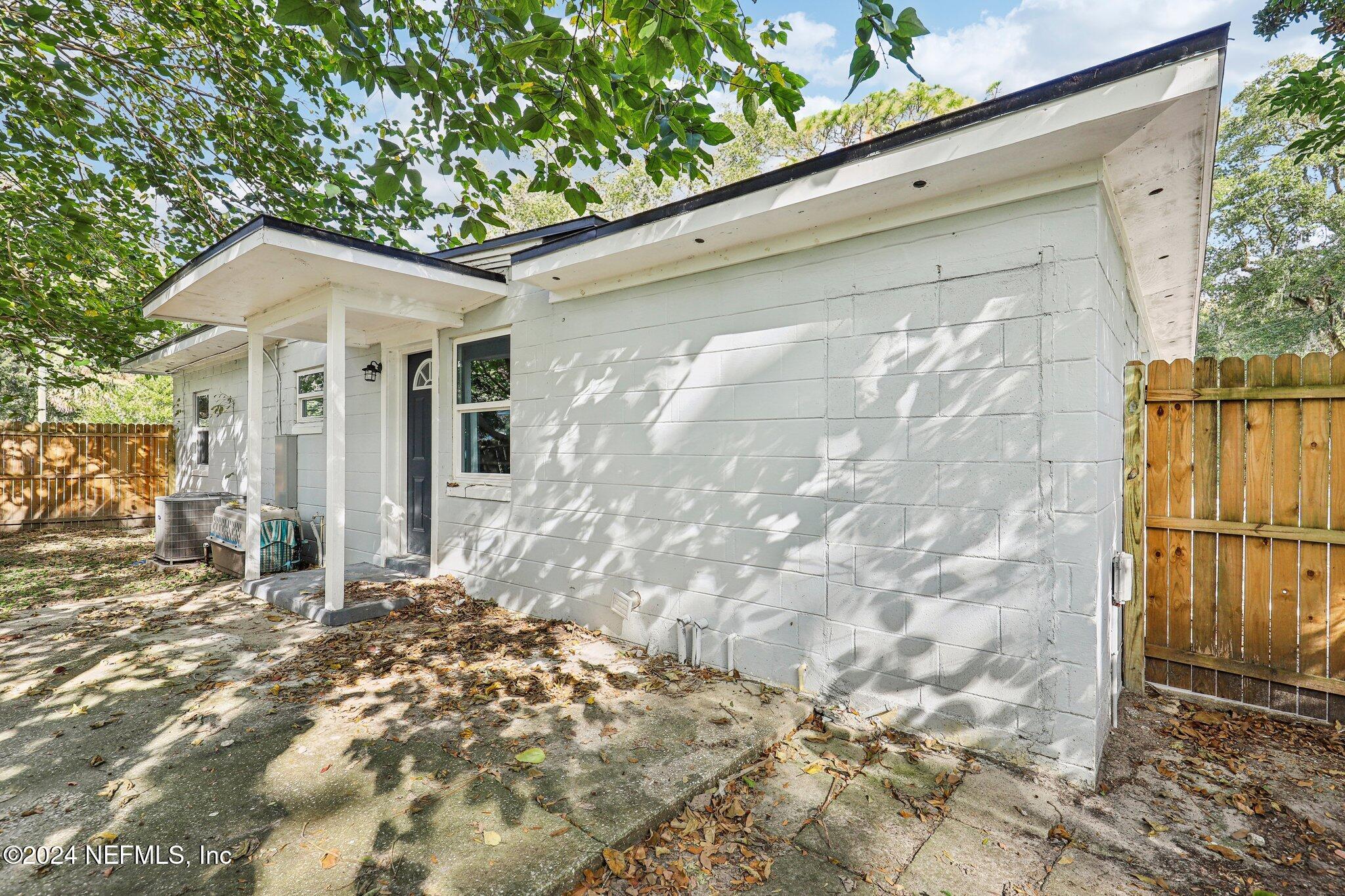 1268 King Arthur Road Jacksonville, FL 32211 - Photo 32 of 35 a patio with table and chairs and potted plants