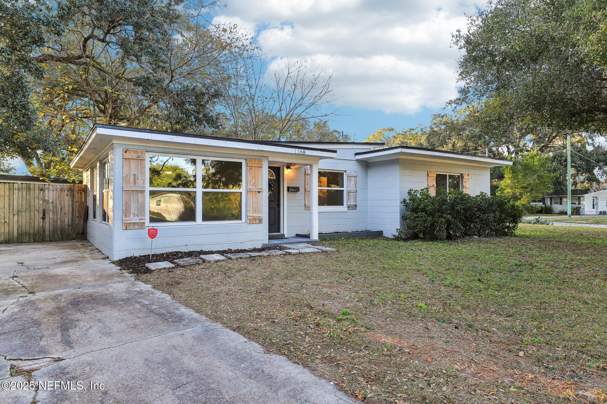 1268 King Arthur Road Jacksonville, FL 32211 - Photo 4 of 35 a view of a house with backyard and garden