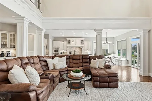 a living room with furniture fireplace and a large window