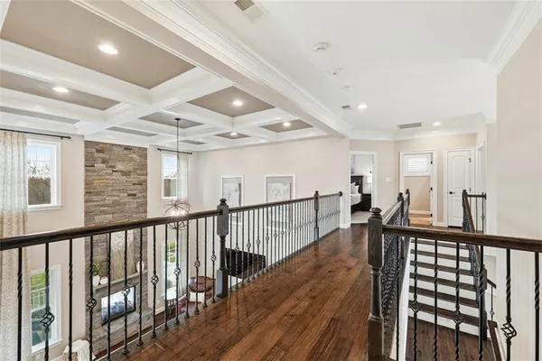 a bedroom with a bed chandelier and a window