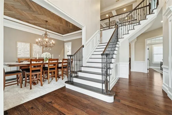 a view of a dining room with furniture wooden floor and a chandelier