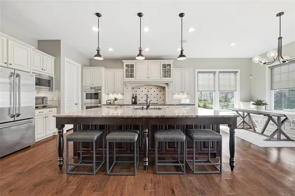 a large kitchen with a table and chairs