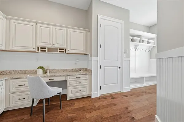 a kitchen with cabinets and wooden floor