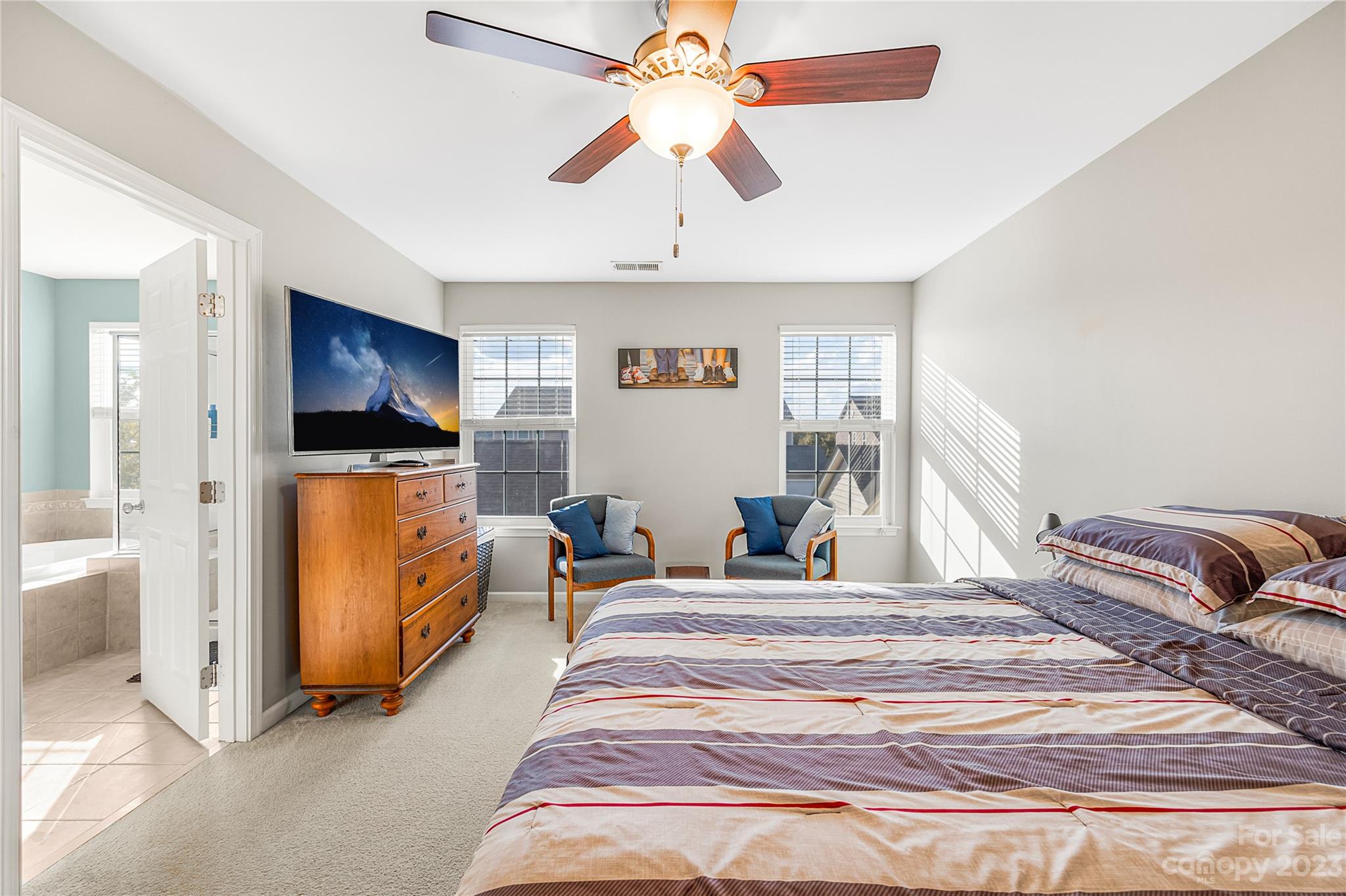 8307 Viewpoint Lane Cornelius, NC 28031 - Photo 12 of 25 a bedroom with a bed and a chandelier