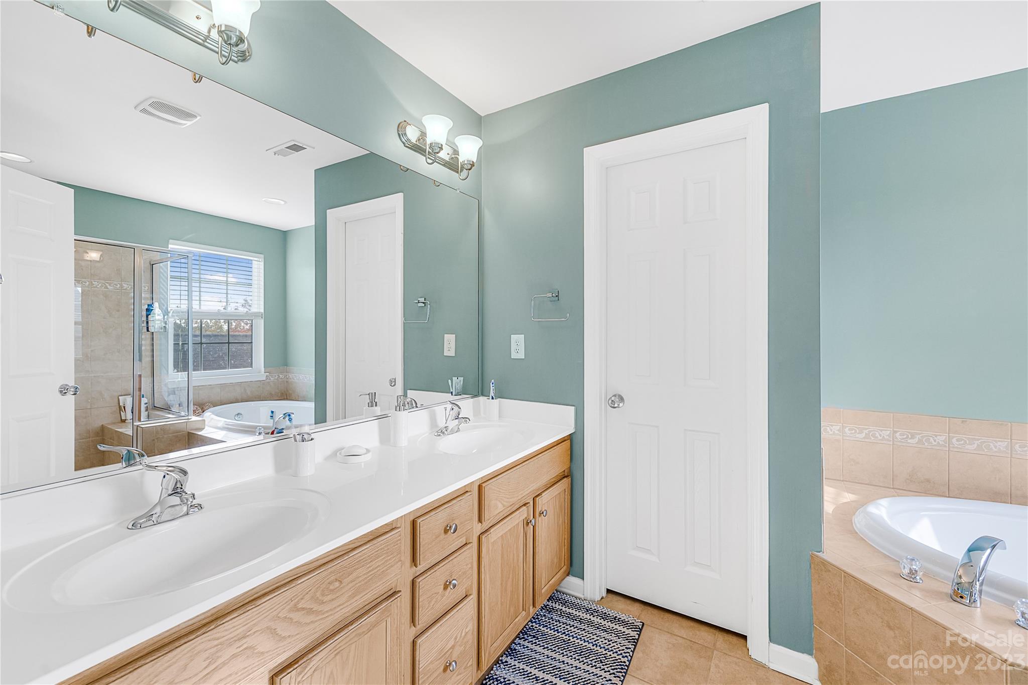 8307 Viewpoint Lane Cornelius, NC 28031 - Photo 13 of 25 a spacious bathroom with a double vanity sink and a mirror