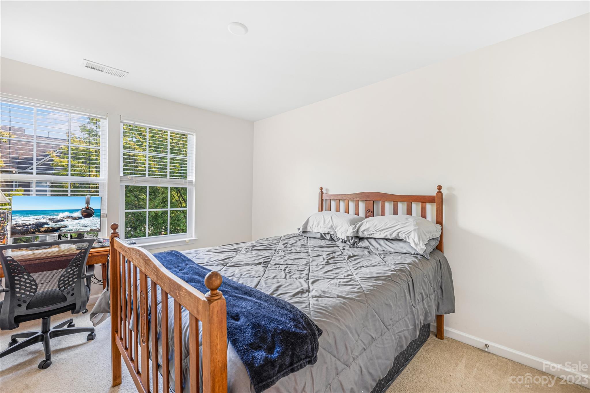 8307 Viewpoint Lane Cornelius, NC 28031 - Photo 16 of 25 a bed sitting in a bedroom next to a window