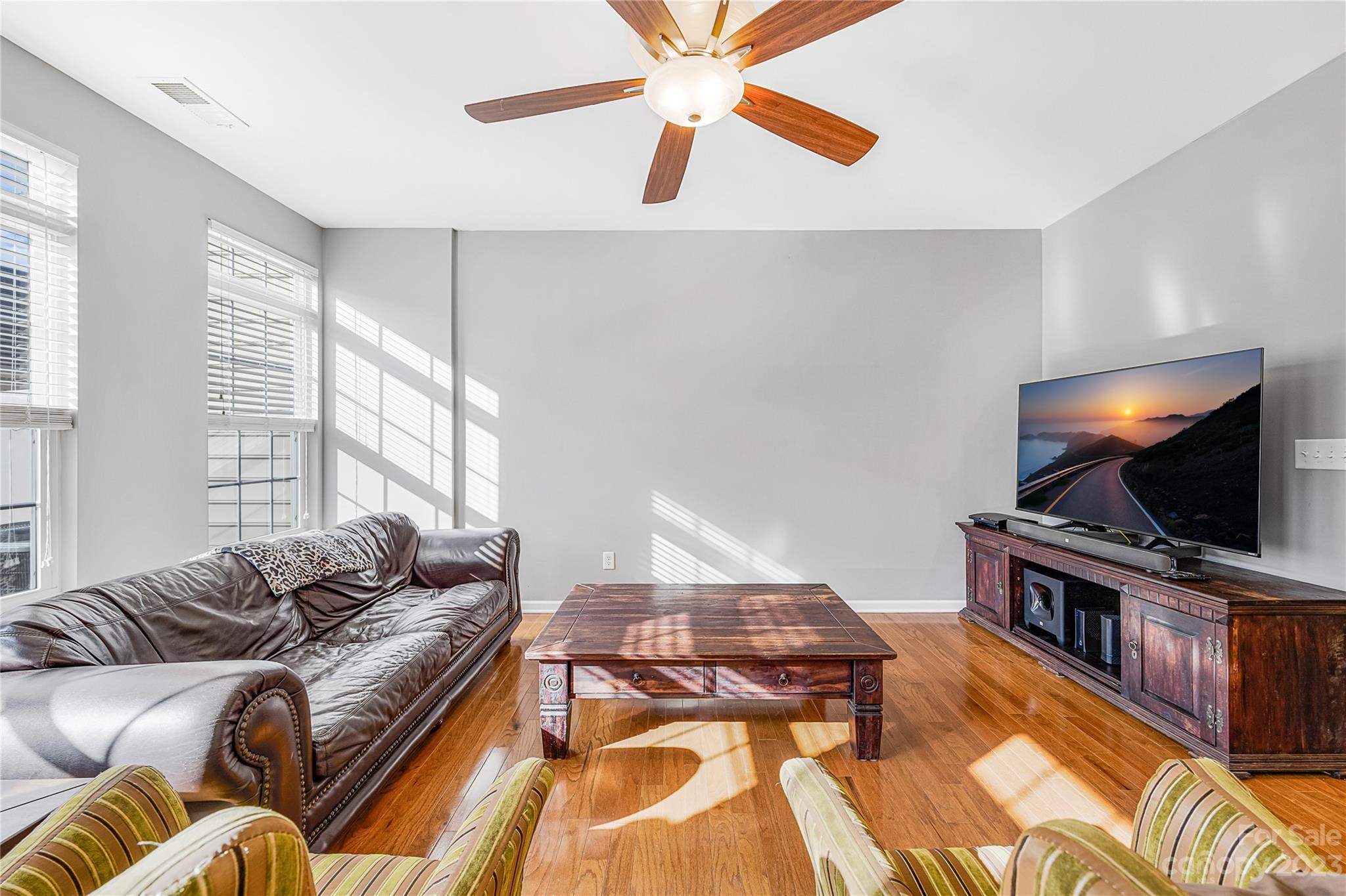 8307 Viewpoint Lane Cornelius, NC 28031 - Photo 6 of 25 a living room with furniture and a flat screen tv