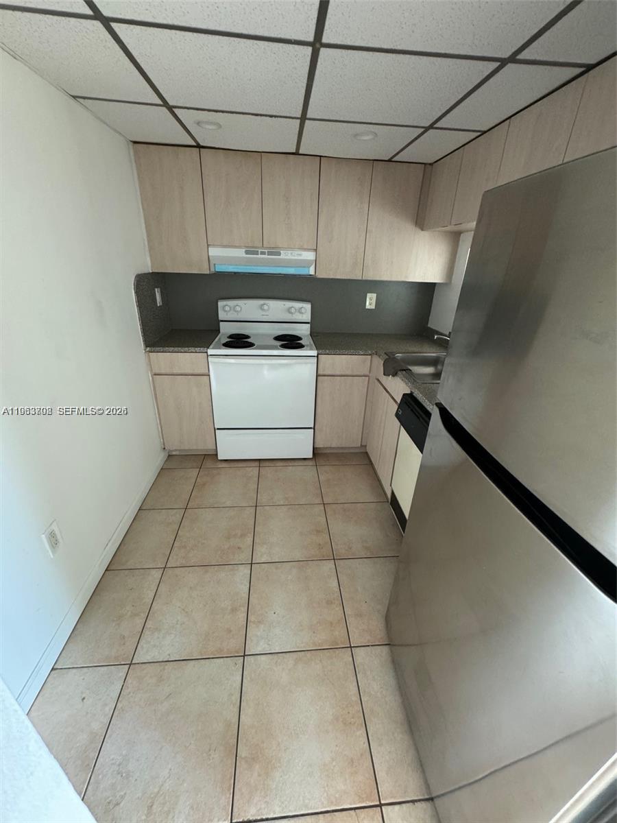 11790 Southwest 18th Street, Unit 3043 Miami, FL 33175 - Photo 12 of 12 a kitchen with a cabinets and appliances