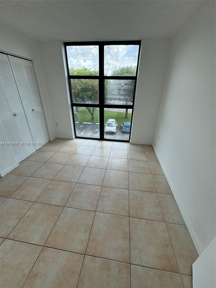 11790 Southwest 18th Street, Unit 3043 Miami, FL 33175 - Photo 6 of 12 a view of an empty room with a window