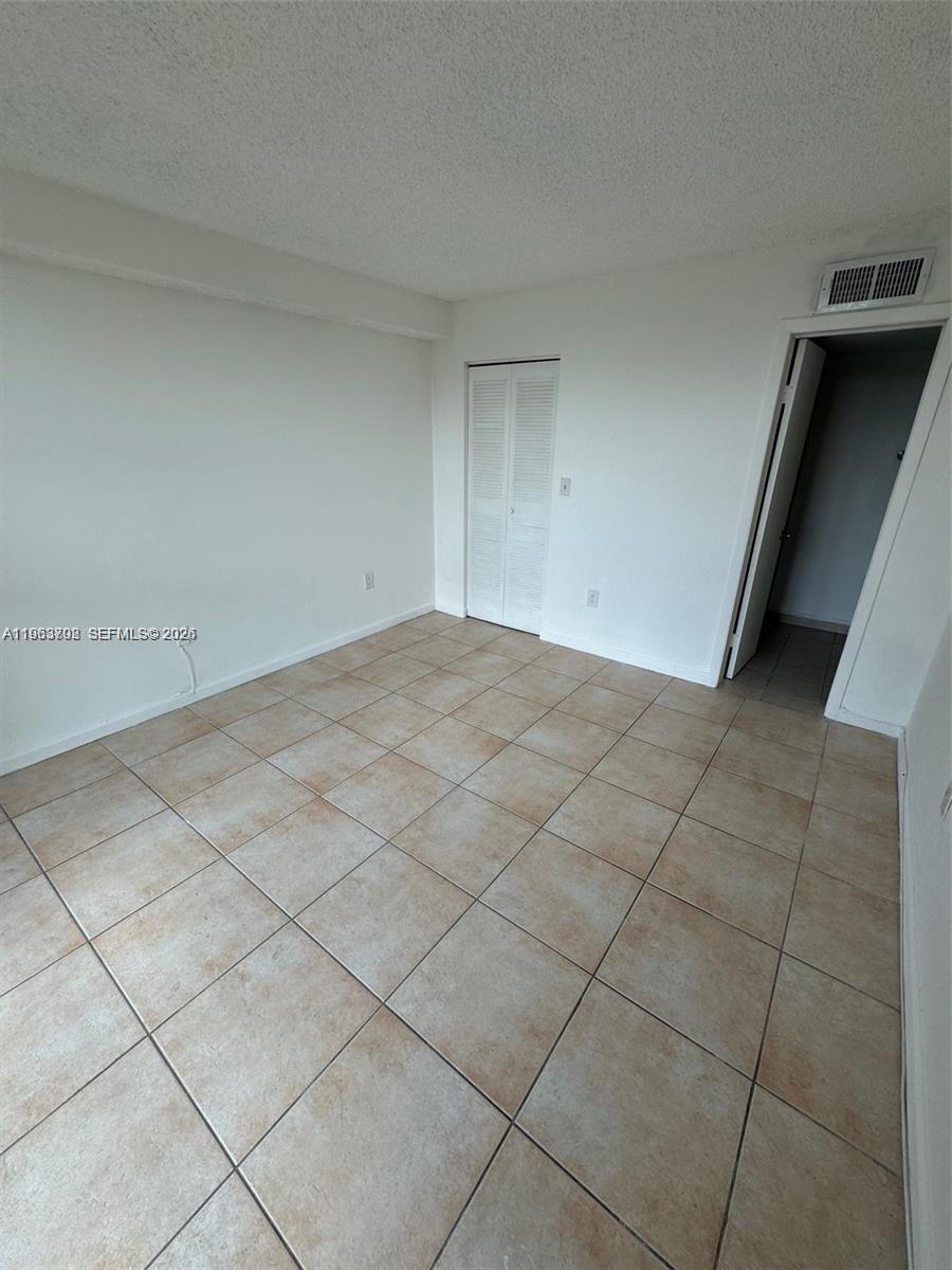 11790 Southwest 18th Street, Unit 3043 Miami, FL 33175 - Photo 7 of 12 a view of an empty room and a window
