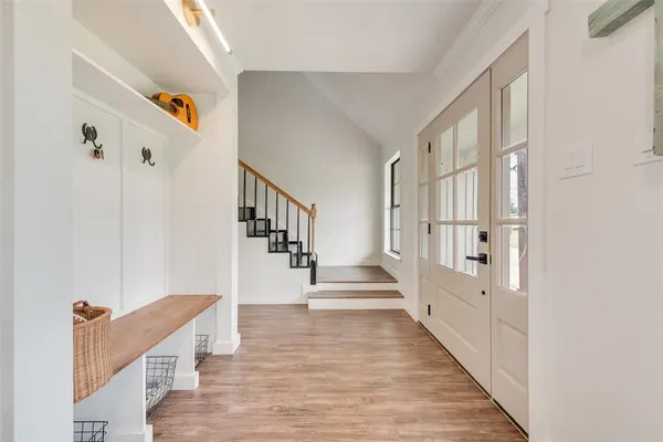 a view of entryway and hall with wooden floor