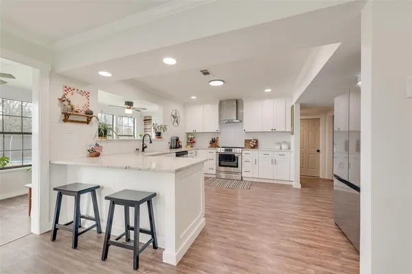 a kitchen with cabinets oven and a sink
