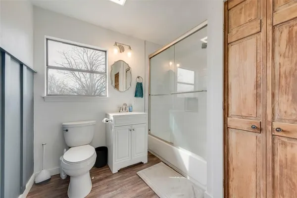 a bedroom with a bed table and a chair