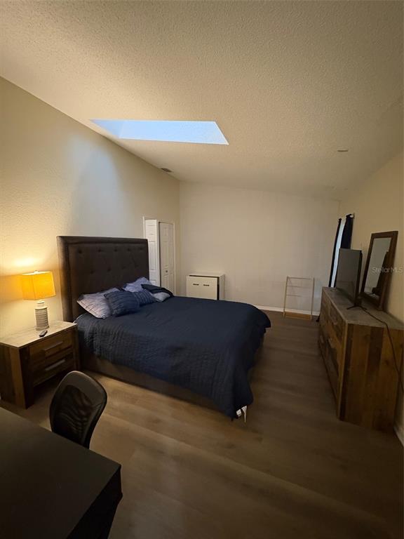 12123 Genoa Street North Port, FL 34287 - Photo 17 of 33 a bedroom with a bed and wooden floor