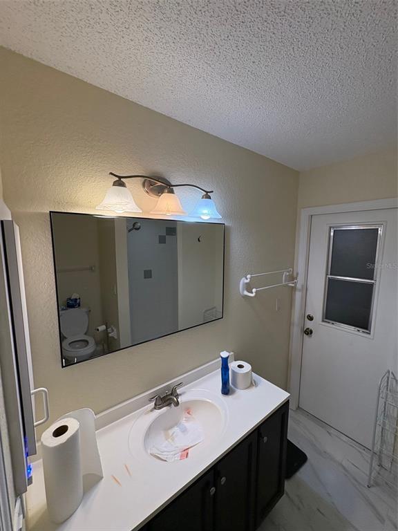 12123 Genoa Street North Port, FL 34287 - Photo 18 of 33 a bathroom with a sink and a mirror