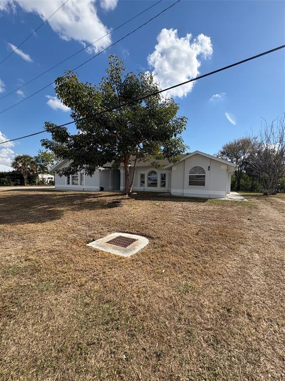 12123 Genoa Street North Port, FL 34287 - Photo 2 of 33 a view of a swimming pool with a yard and a large tree