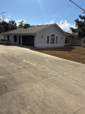 a view of a white house with a outdoor space