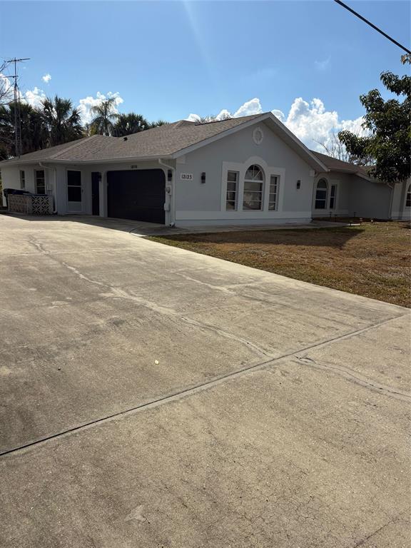 12123 Genoa Street North Port, FL 34287 - Photo 4 of 33 a view of a white house with a outdoor space