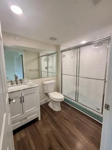 a bathroom with a toilet a sink and a mirror