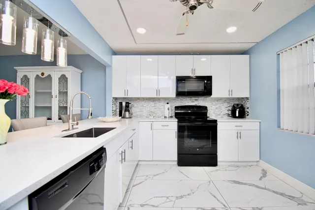 a kitchen with a sink stove and microwave