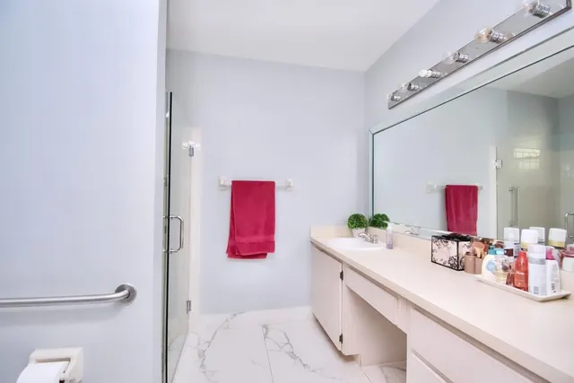 a bathroom with a sink vanity mirror and toilet