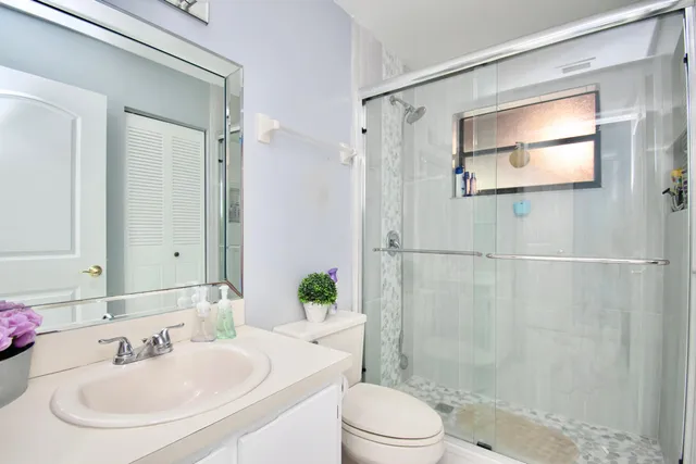 a bathroom with a sink toilet and shower