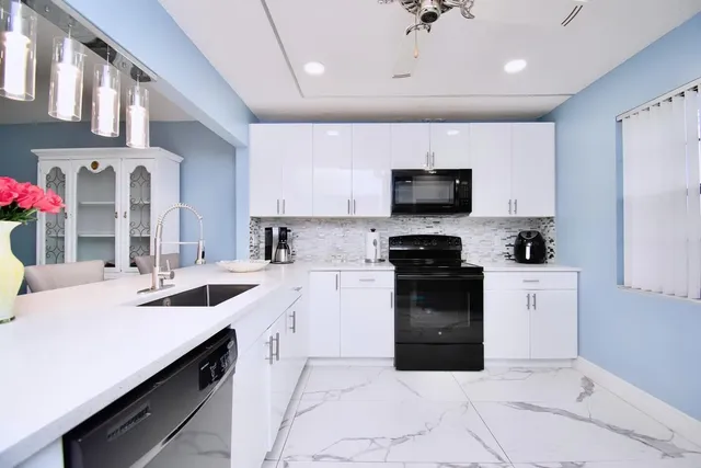a kitchen with a sink stove and microwave