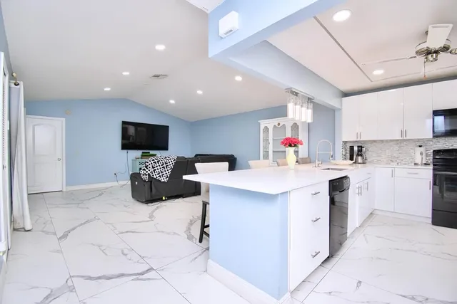 a view of a kitchen with microwave and a stove