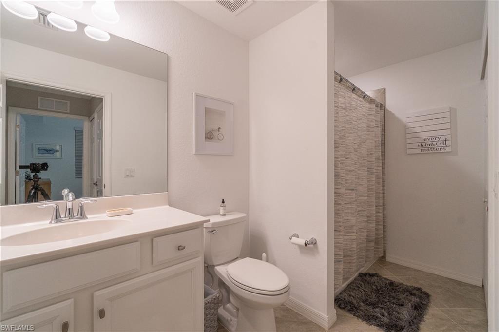 9596 Trevi Court, Unit 5414 Naples, FL 34113 - Photo 17 of 34 a bathroom with a toilet a sink and shower