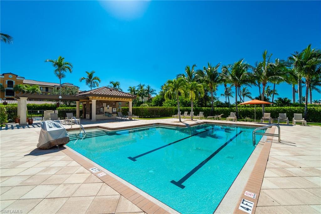 9596 Trevi Court, Unit 5414 Naples, FL 34113 - Photo 26 of 34 a view of a swimming pool with a patio and a yard