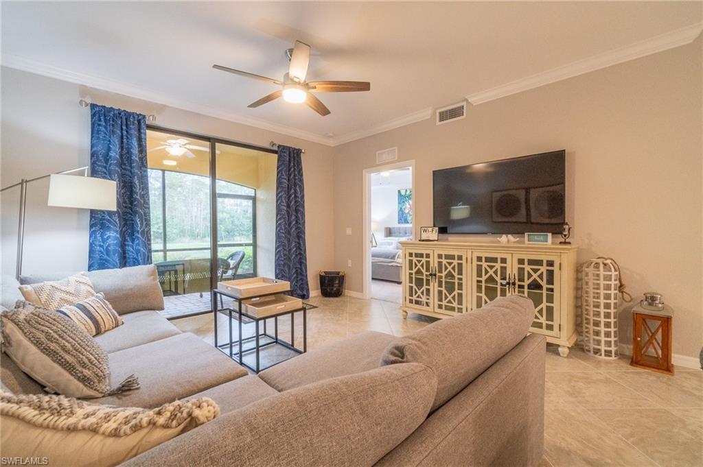 9596 Trevi Court, Unit 5414 Naples, FL 34113 - Photo 3 of 34 a living room with furniture and a flat screen tv