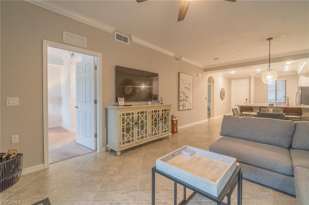 9596 Trevi Court, Unit 5414 Naples, FL 34113 - Photo 4 of 34 a living room with furniture and a flat screen tv