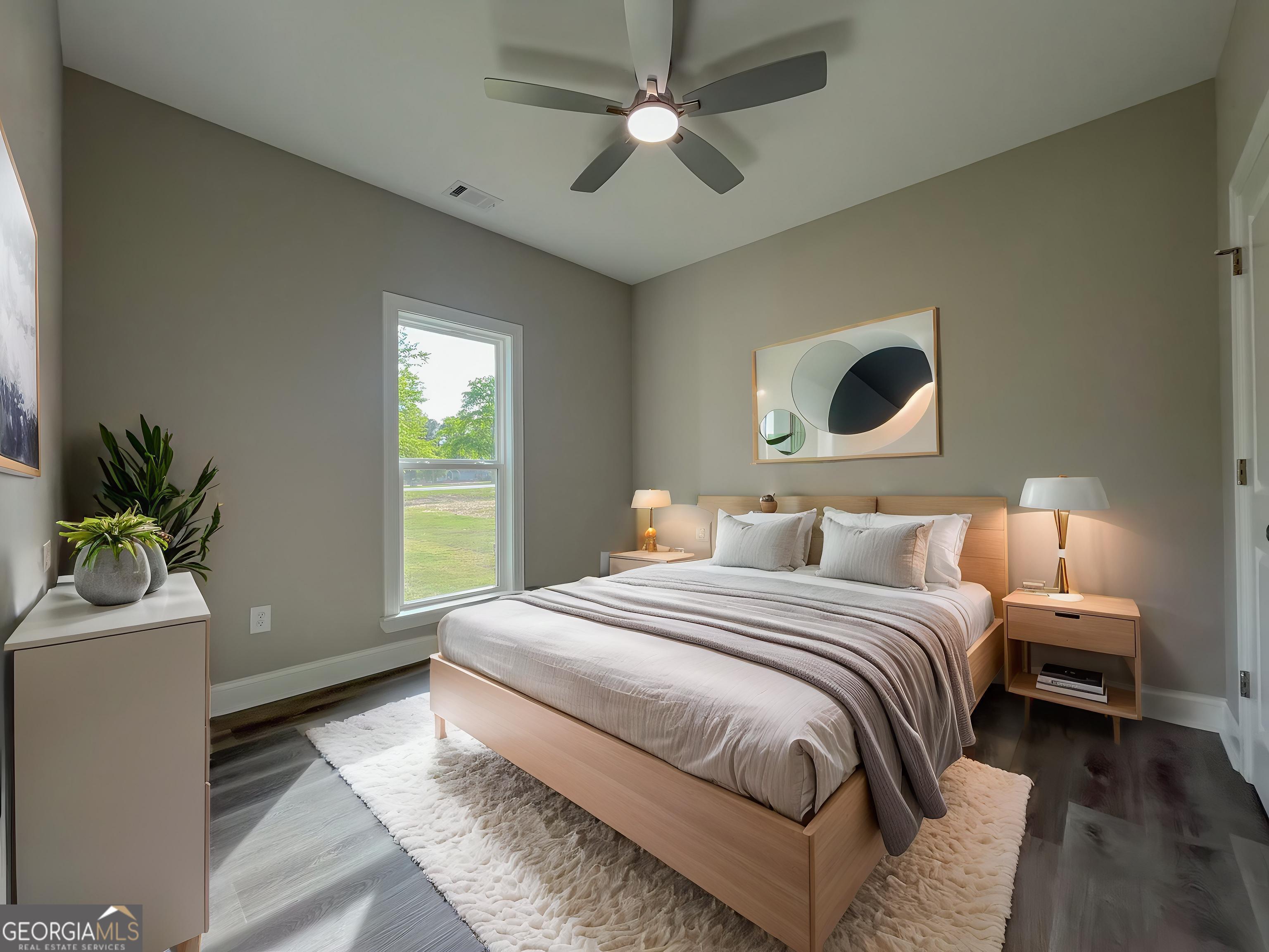 711 Flanders Lane Dublin, GA 31021 - Photo 32 of 49 a bedroom with a bed and a potted plant