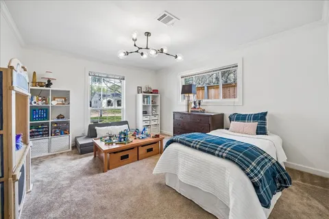 a bedroom with a bed furniture and decor