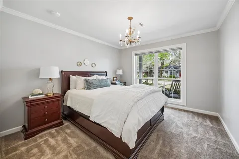 a bedroom with a large bed and a chandelier
