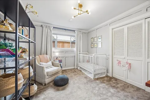 a bedroom with furniture and a window