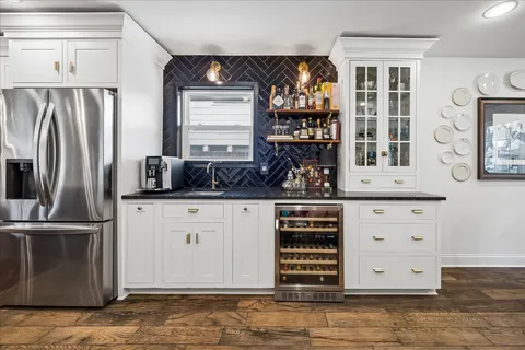 a kitchen with stainless steel appliances granite countertop a refrigerator and a stove