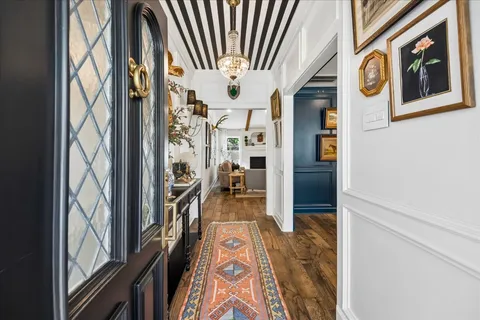 a view of an entryway with wooden floor and a livingroom view