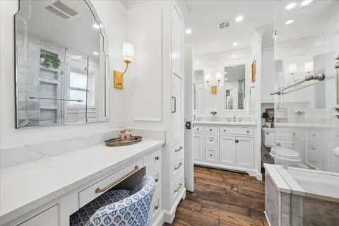a bathroom with a double vanity sink a mirror and shower