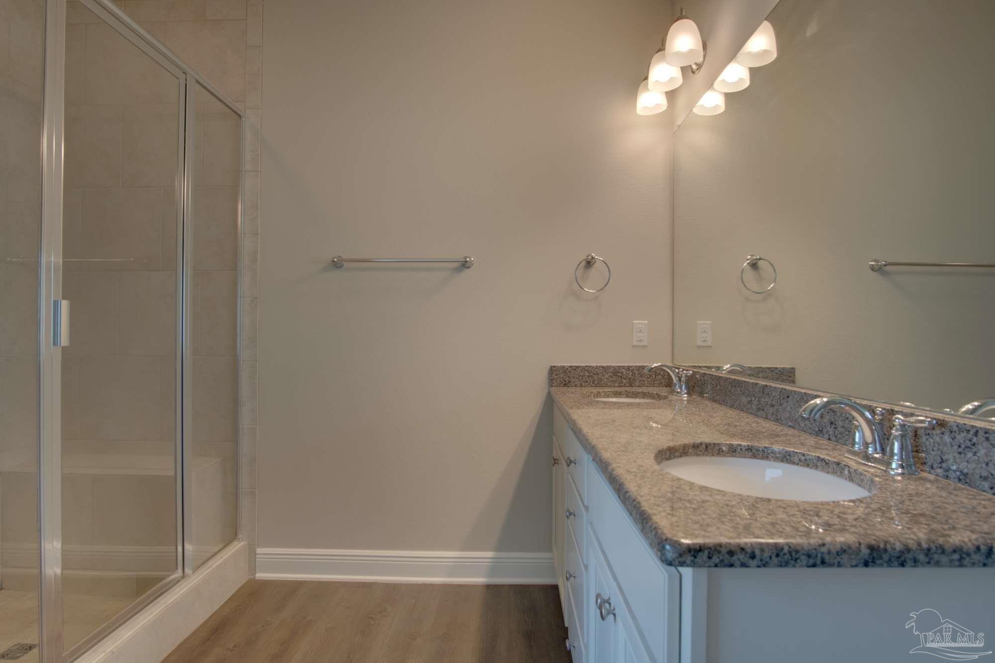 6239 Ladera Trail Pace, FL 32571 - Photo 18 of 27 a bathroom with a granite countertop sink and a mirror
