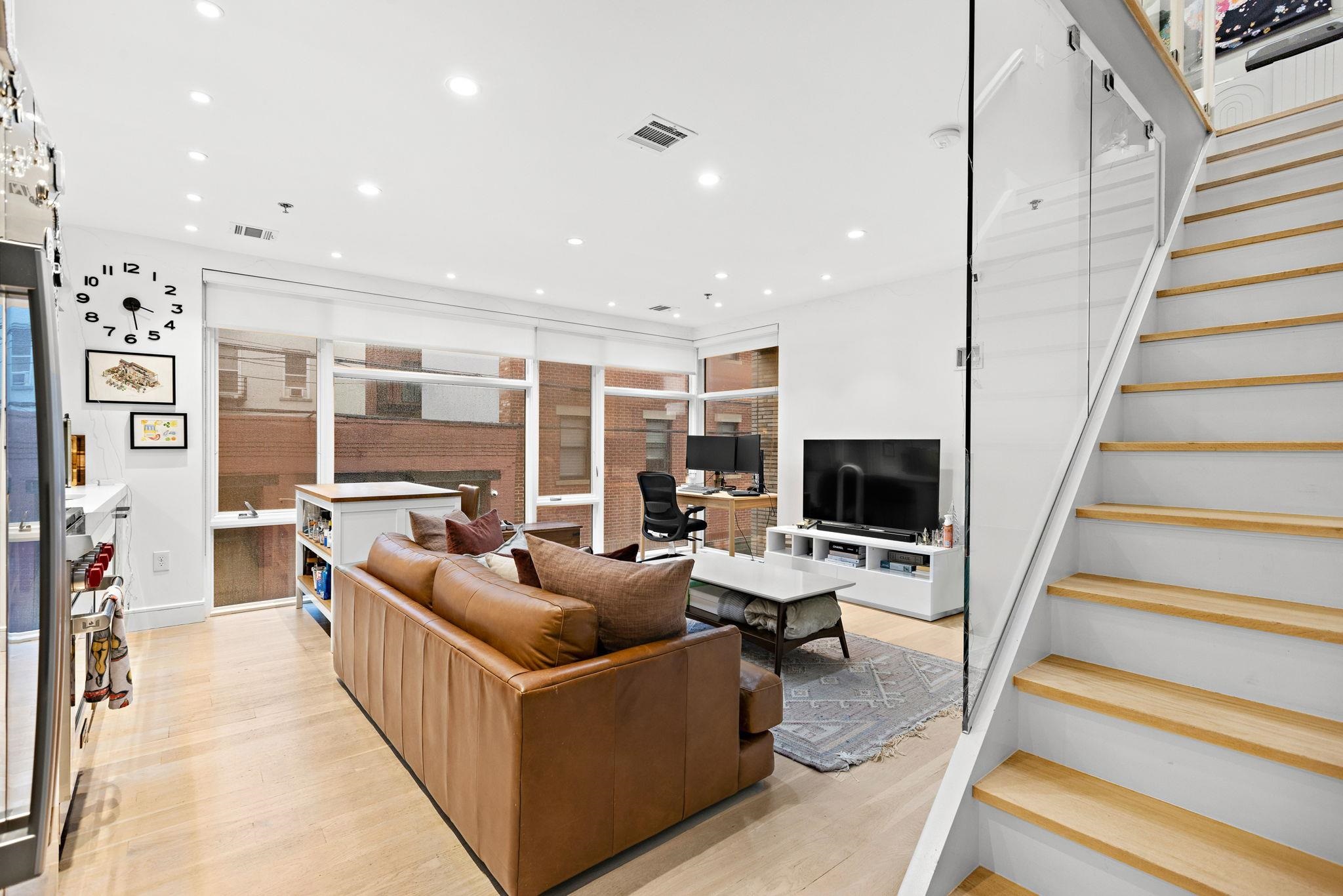 313 Washington Street, Unit 7 Hoboken, NJ 07030 - Photo 1 of 15 a living room with furniture and a flat screen tv