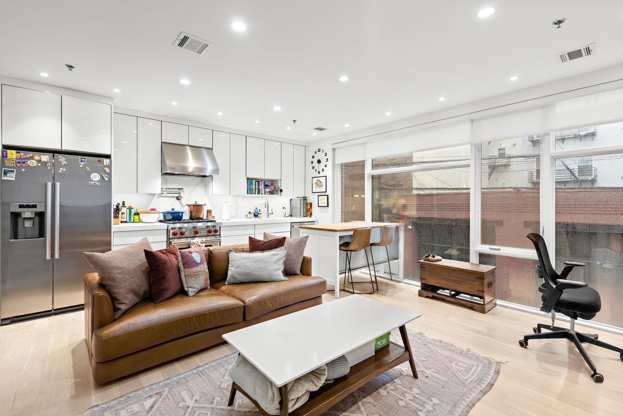 313 Washington Street, Unit 7 Hoboken, NJ 07030 - Photo 3 of 15 a living room filled with furniture and a large window