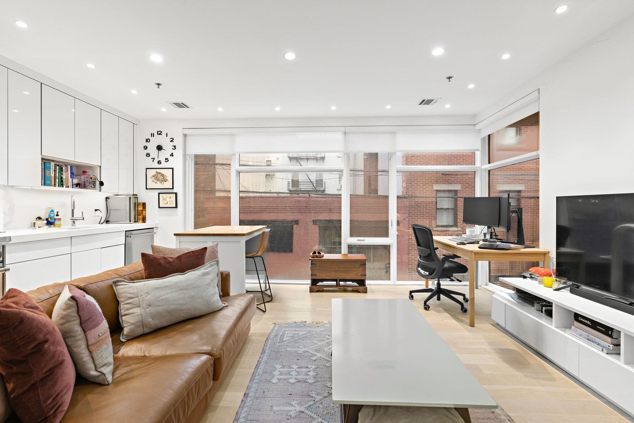 313 Washington Street, Unit 7 Hoboken, NJ 07030 - Photo 6 of 15 a living room with furniture and a flat screen tv
