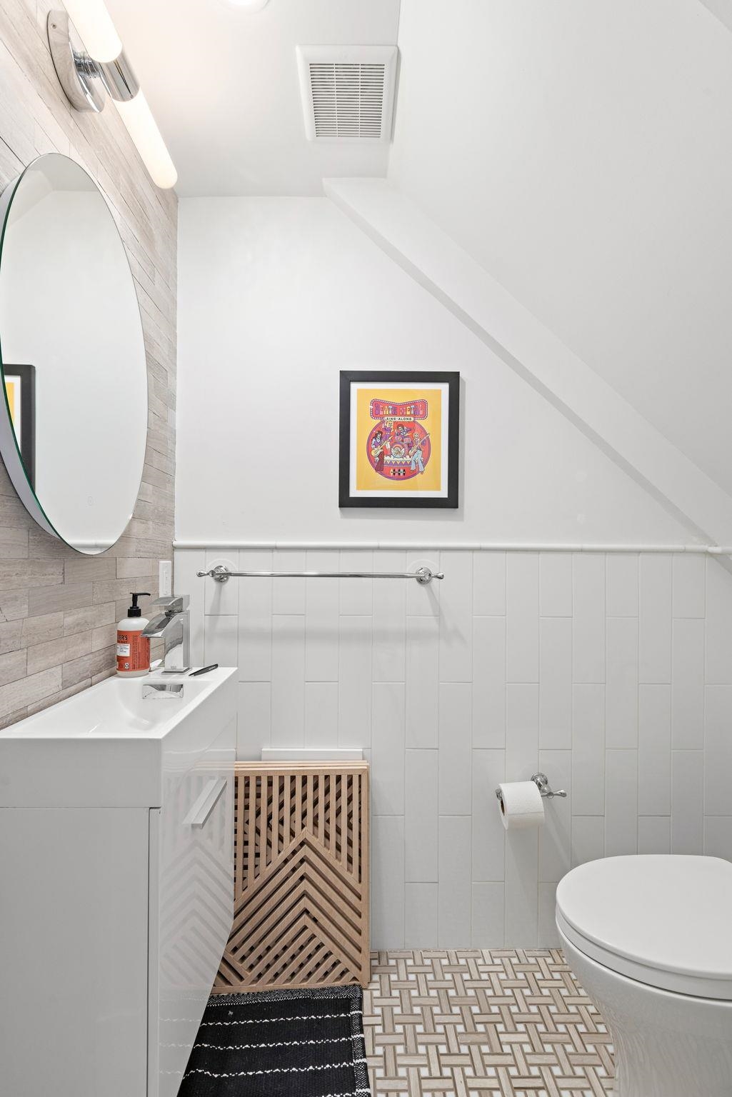 313 Washington Street, Unit 7 Hoboken, NJ 07030 - Photo 7 of 15 a bathroom with a sink toilet and a mirror
