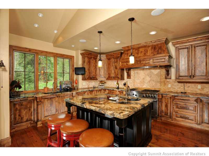 12 Rounds Road Breckenridge, CO 80424 - Photo 6 of 23 a kitchen with granite countertop a stove a sink dishwasher and cabinets with wooden floor
