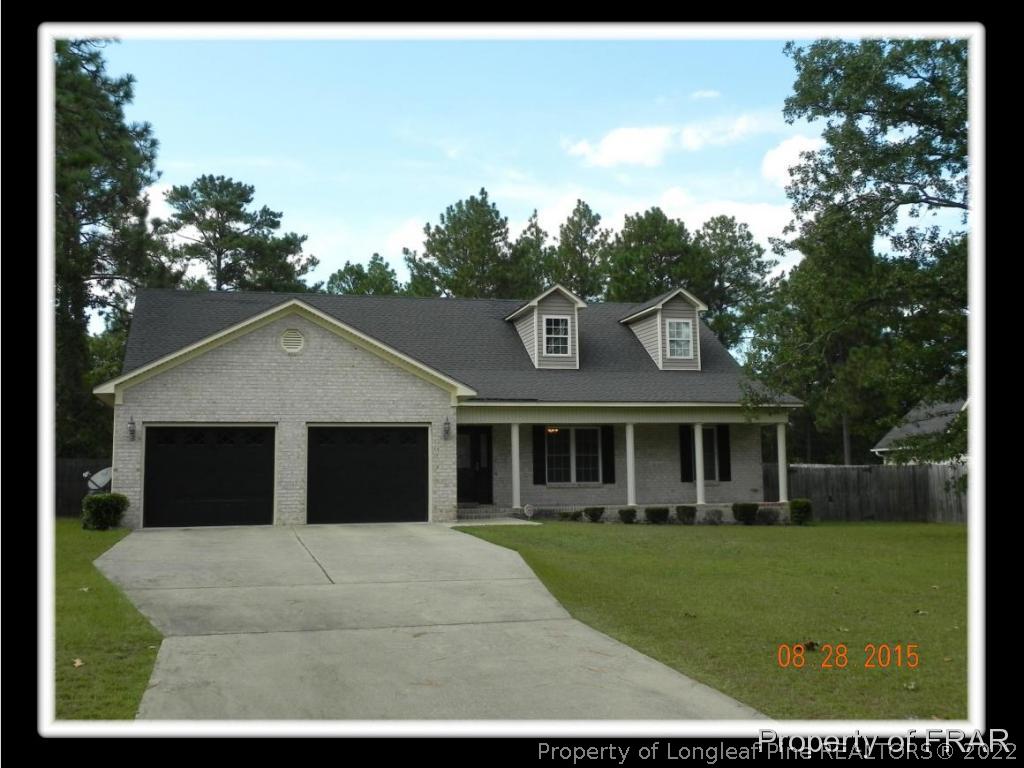 596 East Lake Ridge Road Raeford, NC 28376 - Photo 1 of 25 a front view of a house with a yard