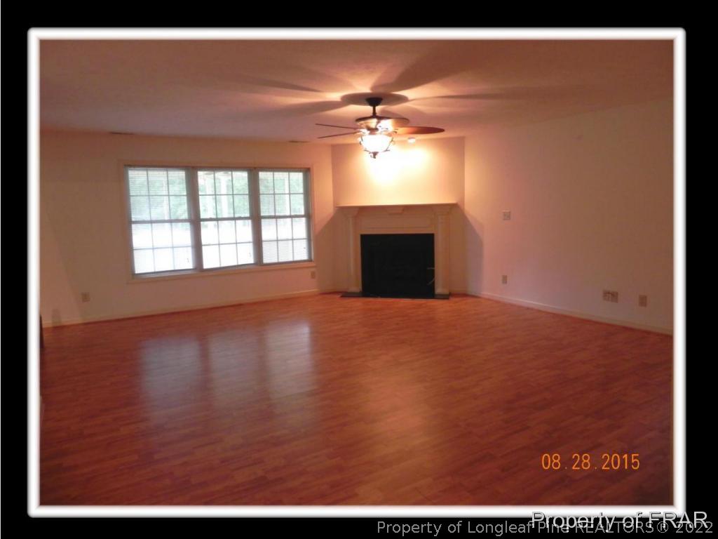 596 East Lake Ridge Road Raeford, NC 28376 - Photo 12 of 25 a view of empty room with wooden floor and fan