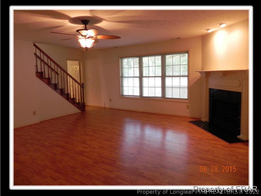 596 East Lake Ridge Road Raeford, NC 28376 - Photo 13 of 25 a view of an empty room with window and wooden floor