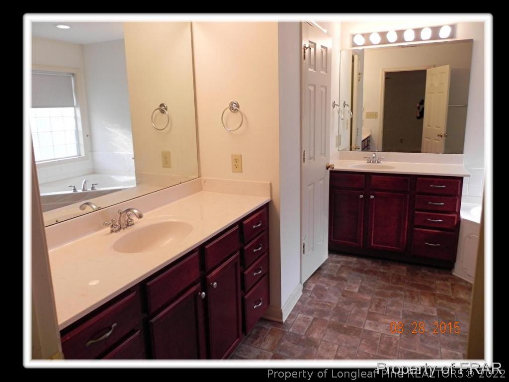 596 East Lake Ridge Road Raeford, NC 28376 - Photo 19 of 25 a bathroom with a sink and a mirror