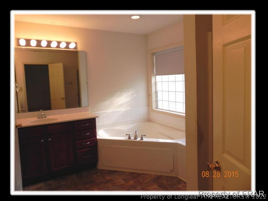 596 East Lake Ridge Road Raeford, NC 28376 - Photo 20 of 25 a bathroom with a bathtub and a sink